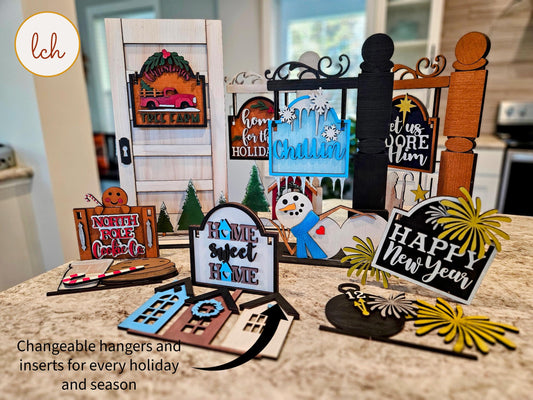 Colorful wooden sign post inserts with holiday and seasonal designs including Christmas and New Year themes