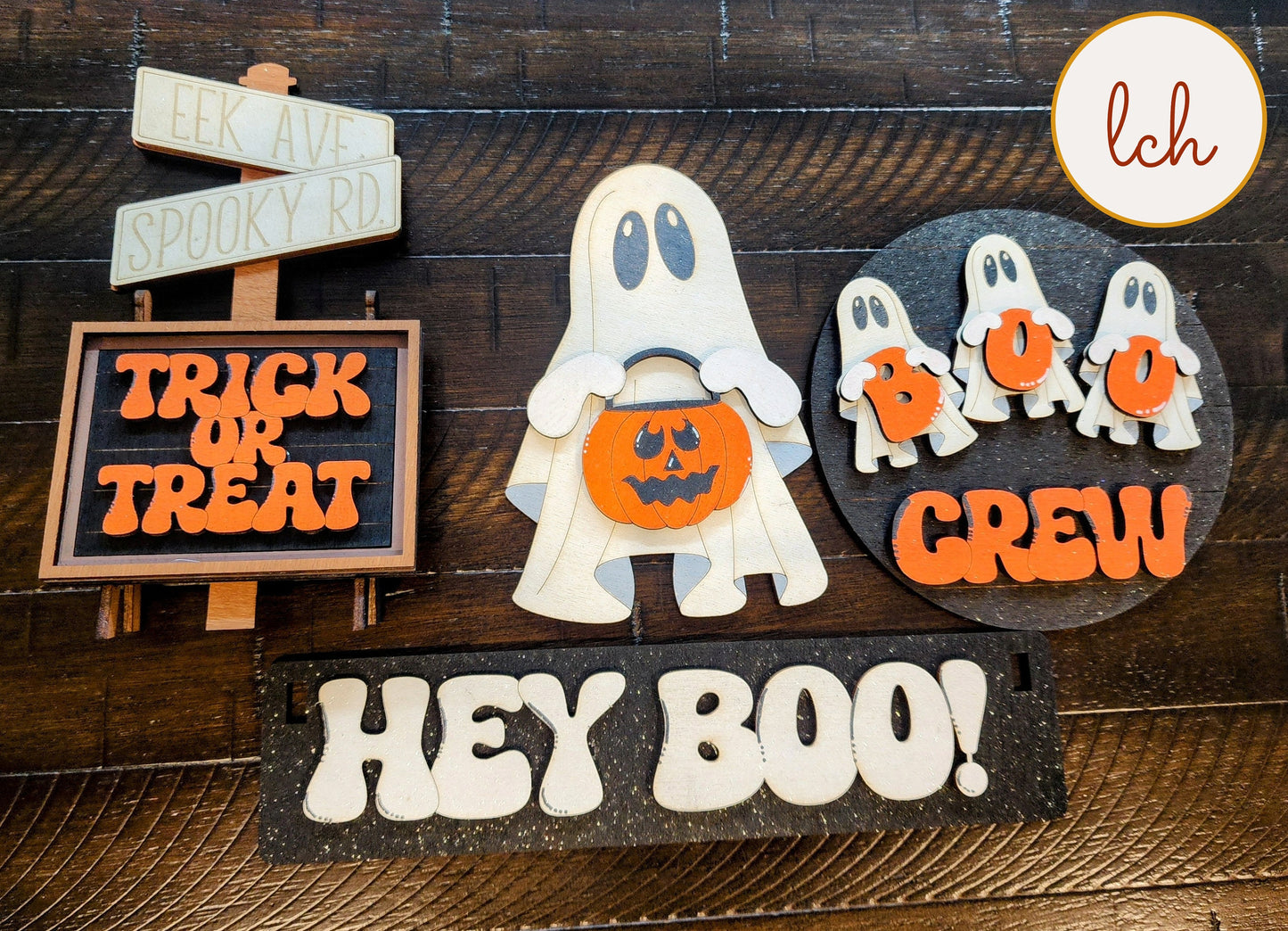 Wooden wagon insert featuring hand painted Halloween ghost decor with trick or treat and hey boo signs