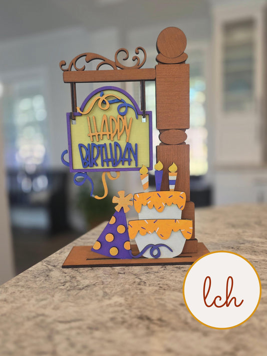 Wooden sign post insert with colorful happy birthday message, birthday cake, candles, and party hat decoration