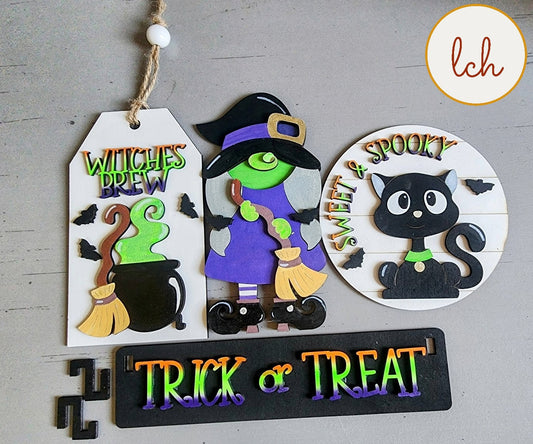 Wooden wagon insert with Halloween-themed decorations including witch, black cat, witches brew, and trick or treat signs