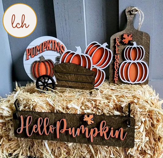 Wooden wagon insert with fall decorations including pumpkins and signs saying Hello Pumpkin and Fall Harvest