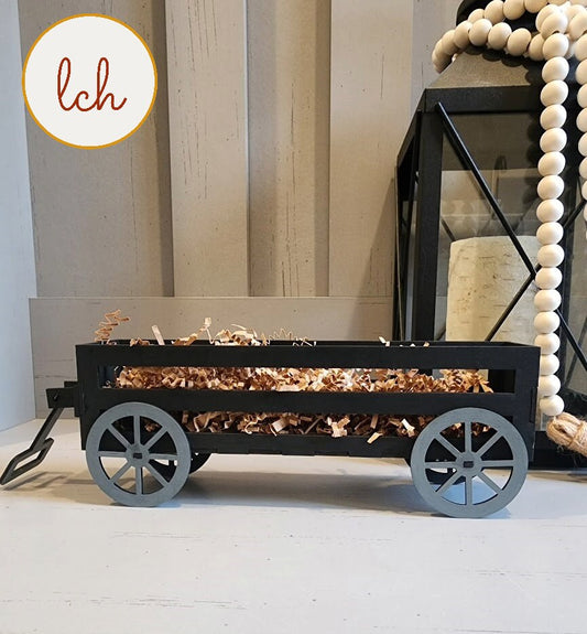 Black wooden wagon insert filled with decorative brown shredded paper for home decor