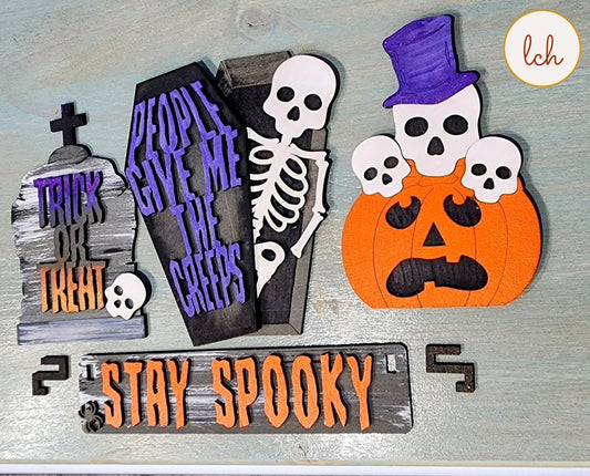 Halloween themed wooden wagon insert with skeletons, coffin, pumpkin, tombstone, and Stay Spooky sign