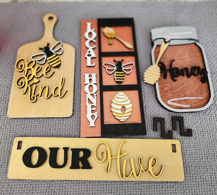 Wooden wagon insert set with bee and honey themed decorative pieces including Bee Kind, Local Honey, Honey jar, and Our Hive signs