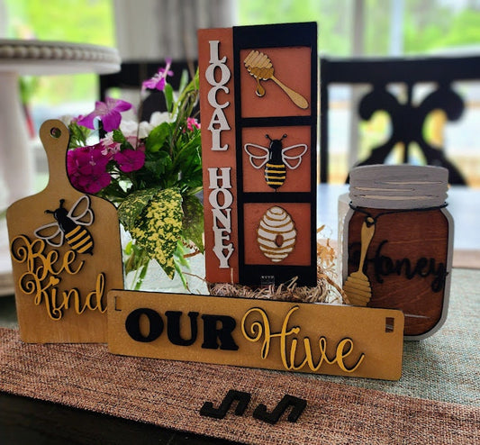 Wooden wagon insert with bee and honey designs including Bee Kind, Local Honey, and Our Hive decorations