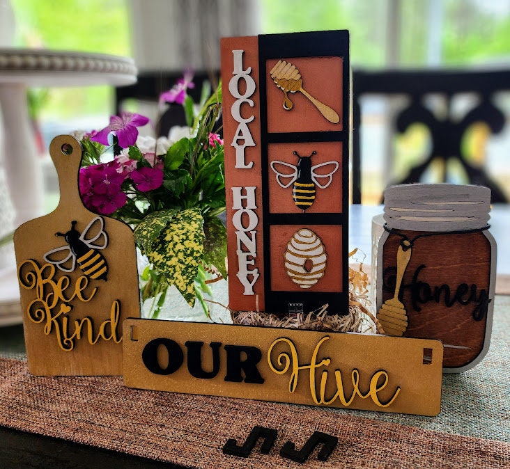 Wooden wagon insert with bee and honey themed decorations including local honey sign and bee kind cutting board