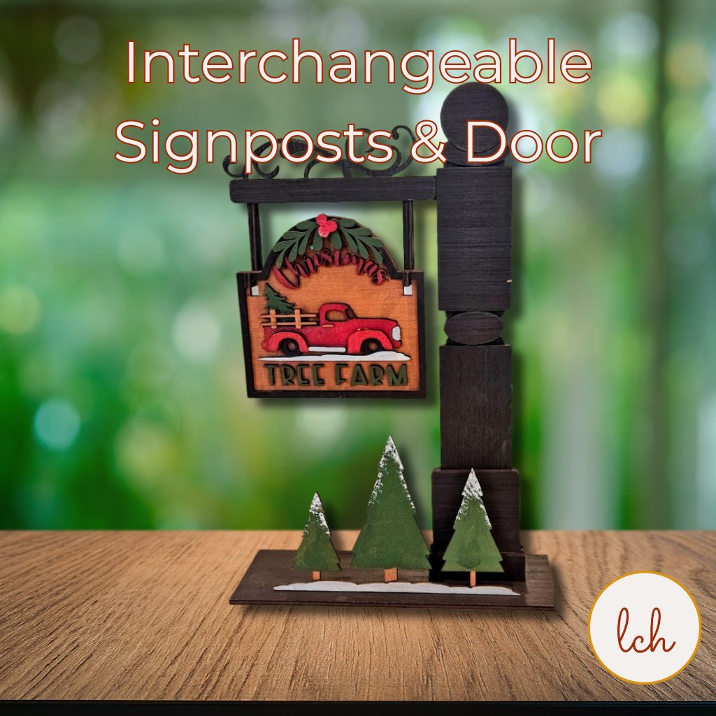 Interchangeable mini signpost decor featuring seasonal and holiday wooden door signs with festive designs on a kitchen countertop