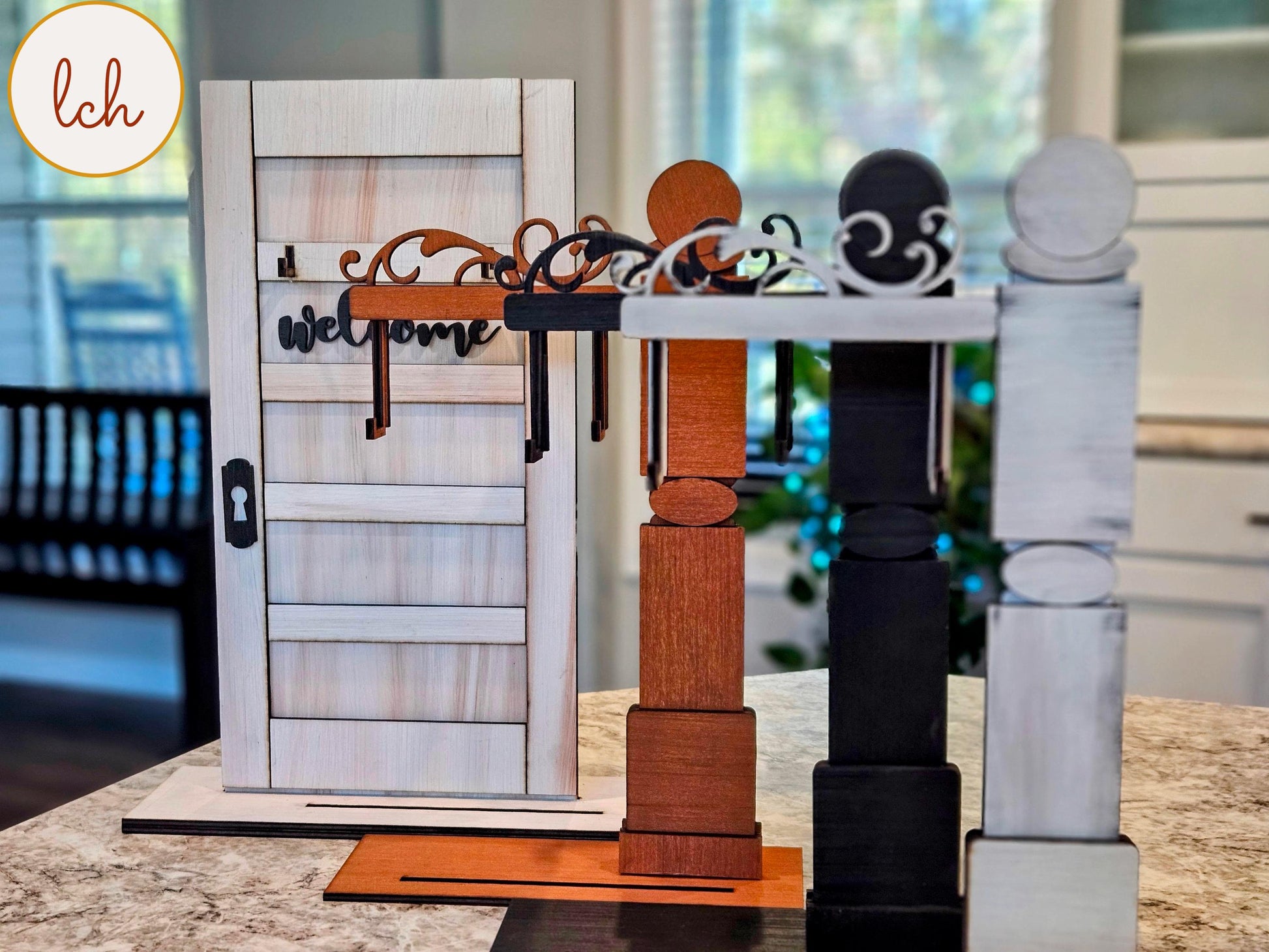 Wooden sign post inserts in white, black, and natural wood colors displayed on a kitchen countertop