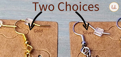 Close-up of gold and silver earring hooks displayed on brown cards with two choices shown
