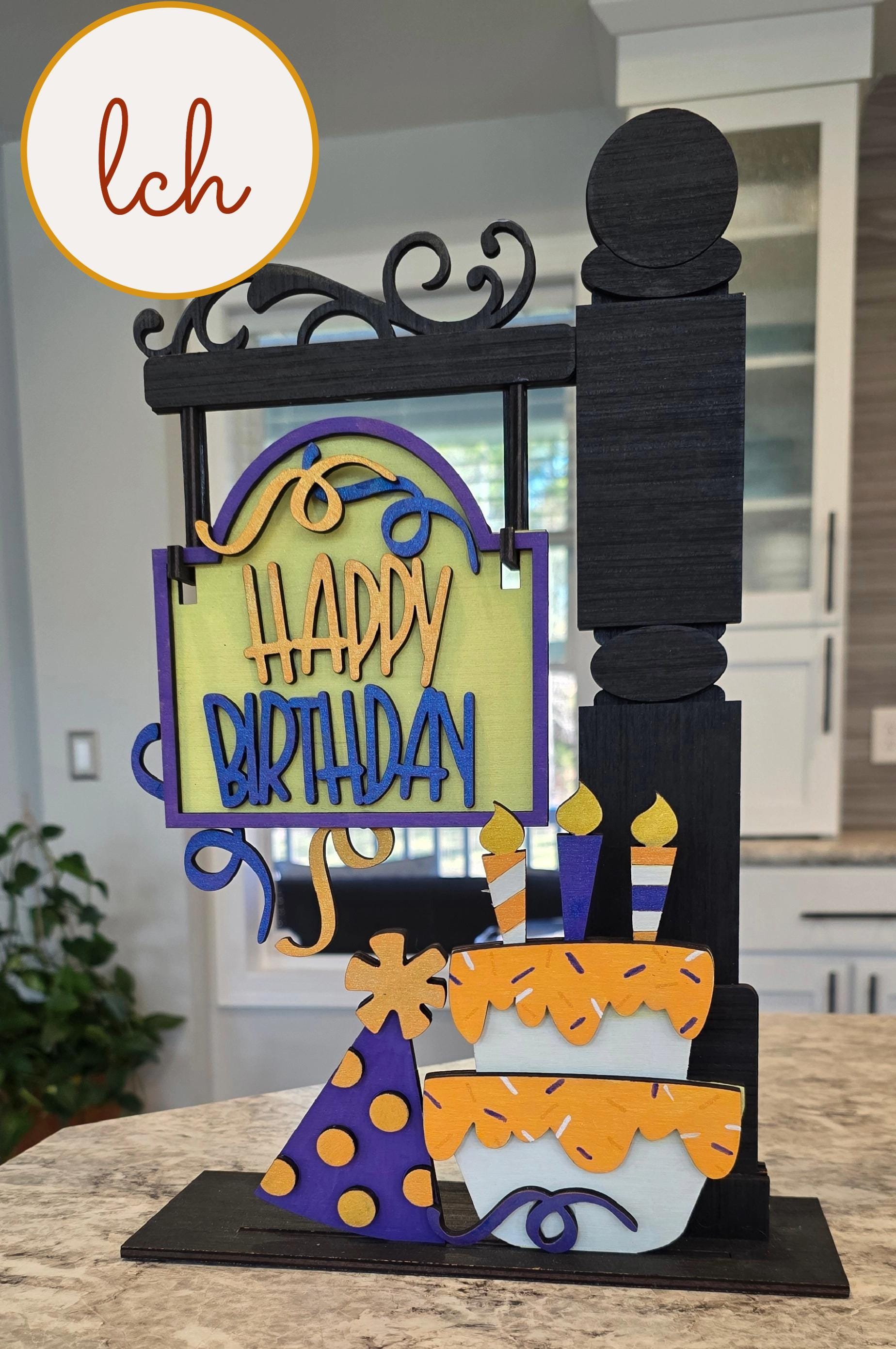 Wooden sign post insert with happy birthday message, birthday cake, candles, and party hat decorations