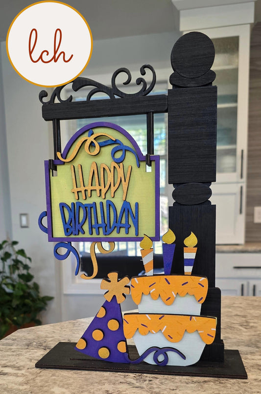 Wooden sign post insert with happy birthday message, birthday cake, candles, and party hat decorations