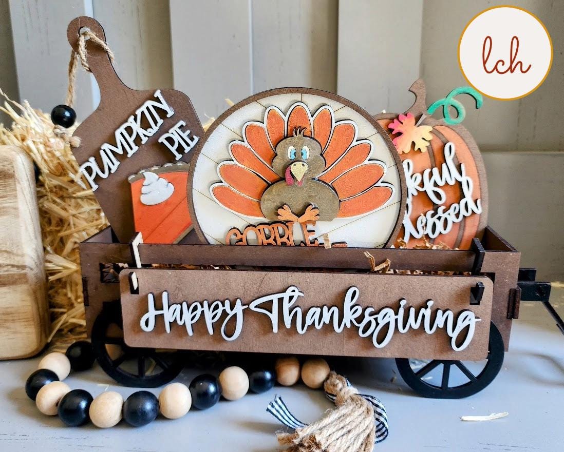 Wooden wagon insert with Thanksgiving theme including a turkey, pumpkin pie, and Happy Thanksgiving sign