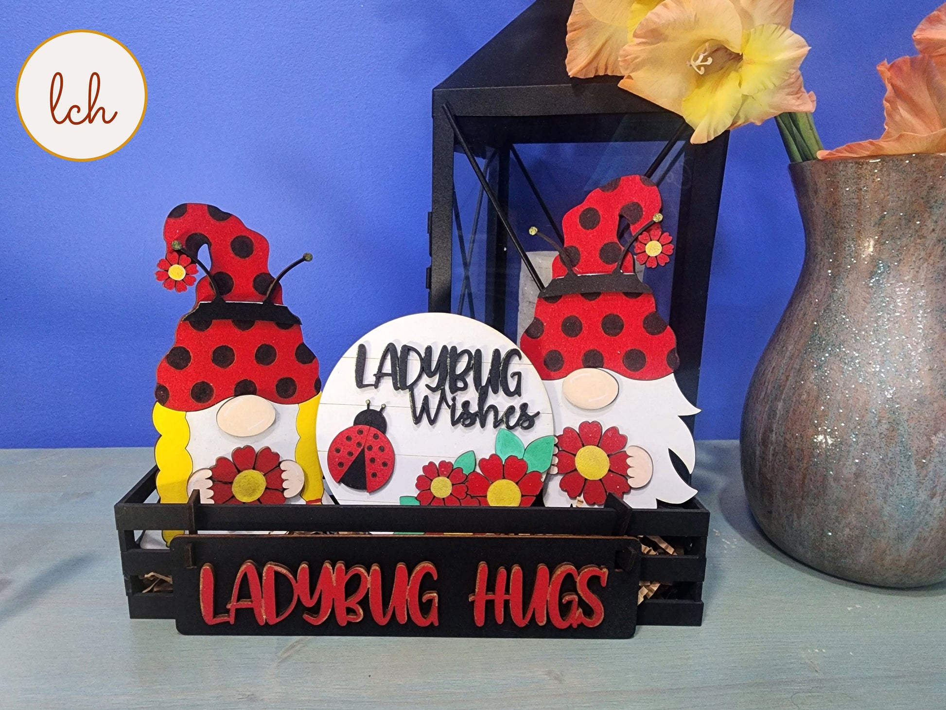 Wooden wagon insert with ladybug-themed gnome decorations and floral accents for spring decor