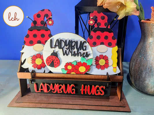Wooden wagon insert with ladybug gnome decorations and ladybug hugs sign for spring decor