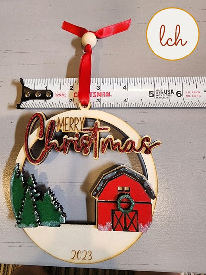2023 Merry Christmas wooden ornament with red barn and green trees hanging on red ribbon