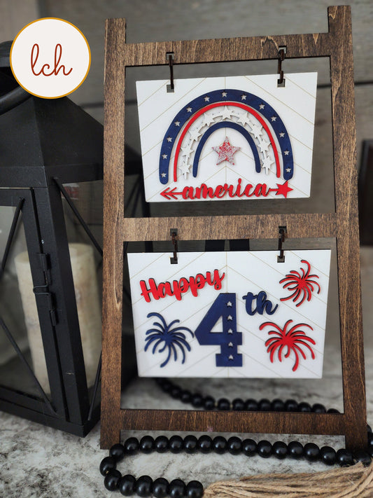 Wooden ladder frame hanger displaying patriotic 4th of July decorations with red white and blue colors