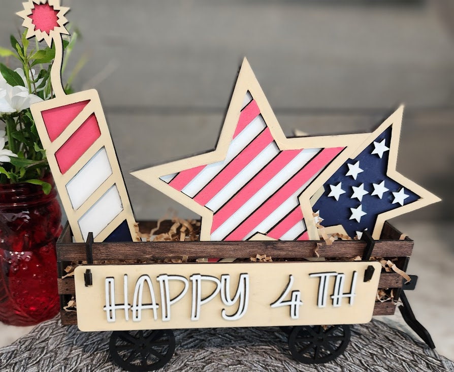 Wooden 4th of July decor insert with star and rocket shapes in red white and blue colors