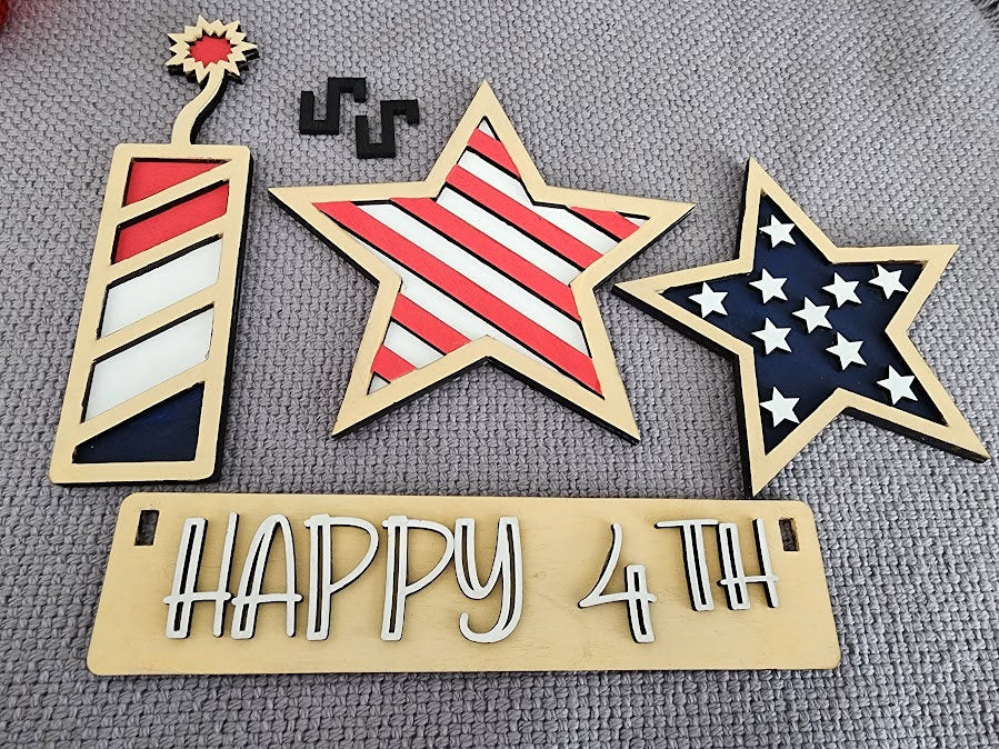 Wooden 4th of July decor insert with patriotic star and firework designs in red white and blue