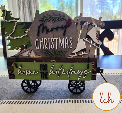 Christmas shelf sitter insert for farmhouse decor featuring wooden holiday themed wagon with ice skates and Christmas tree