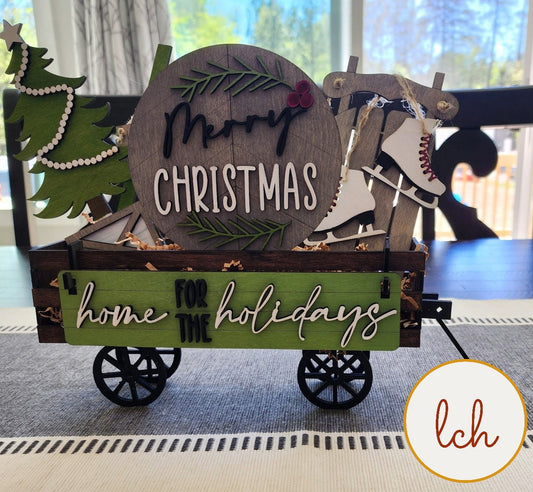Christmas shelf sitter insert for farmhouse decor featuring wooden holiday themed wagon with ice skates and Christmas tree