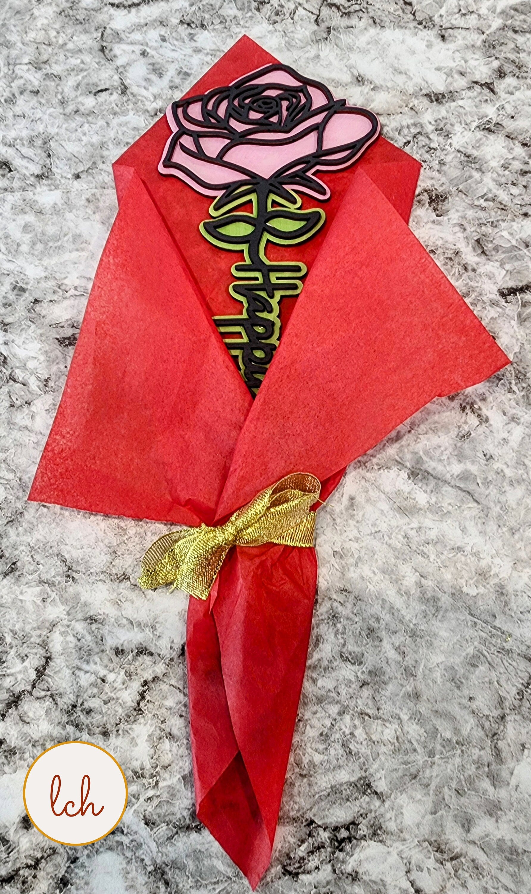 Mother's Day wooden gifts bouquet with a pink wooden rose and Happy Mother's Day message wrapped in red tissue paper