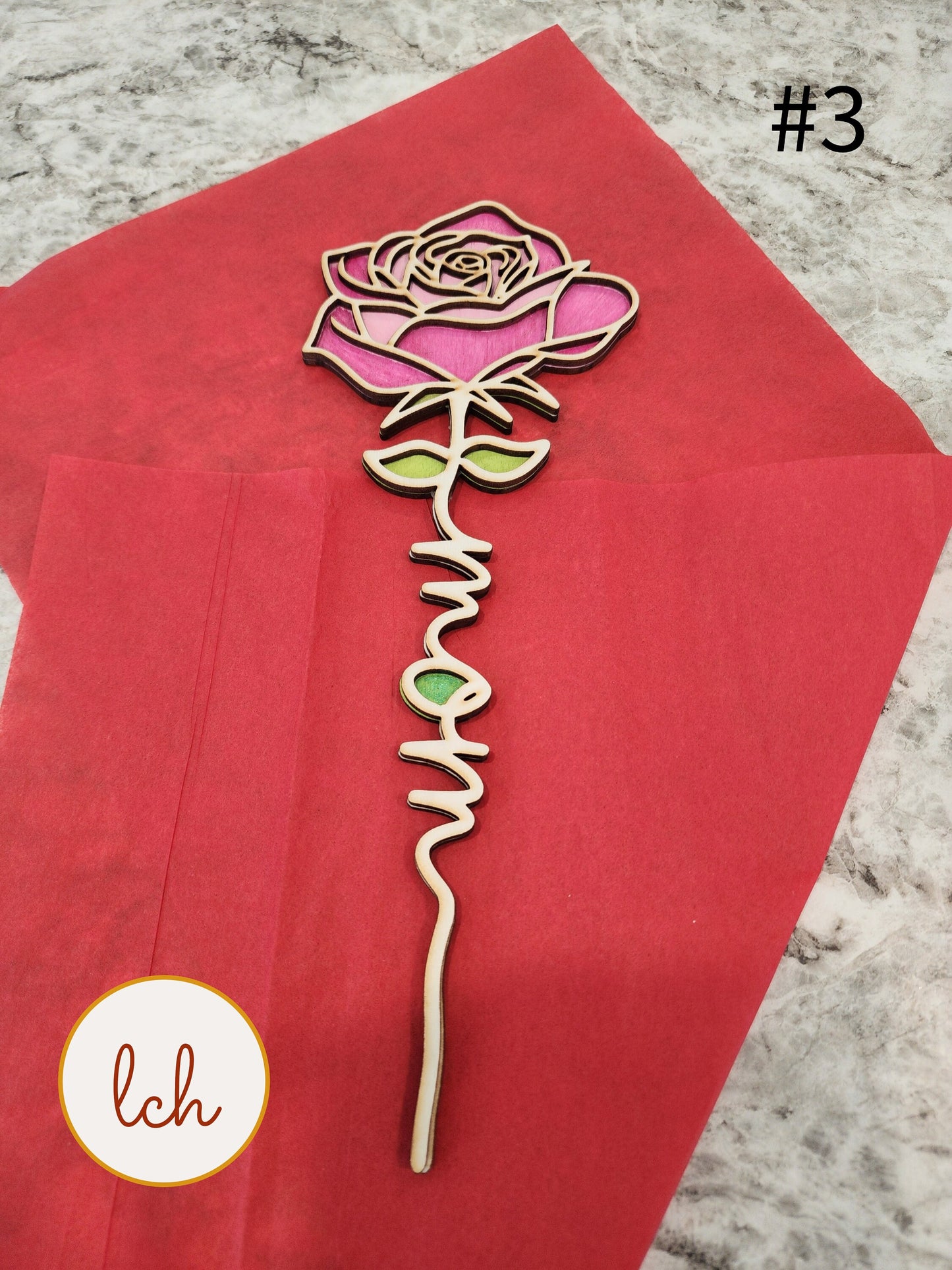 Intricately designed Mother's Day wooden gifts rose with 'mom' inscription on red background