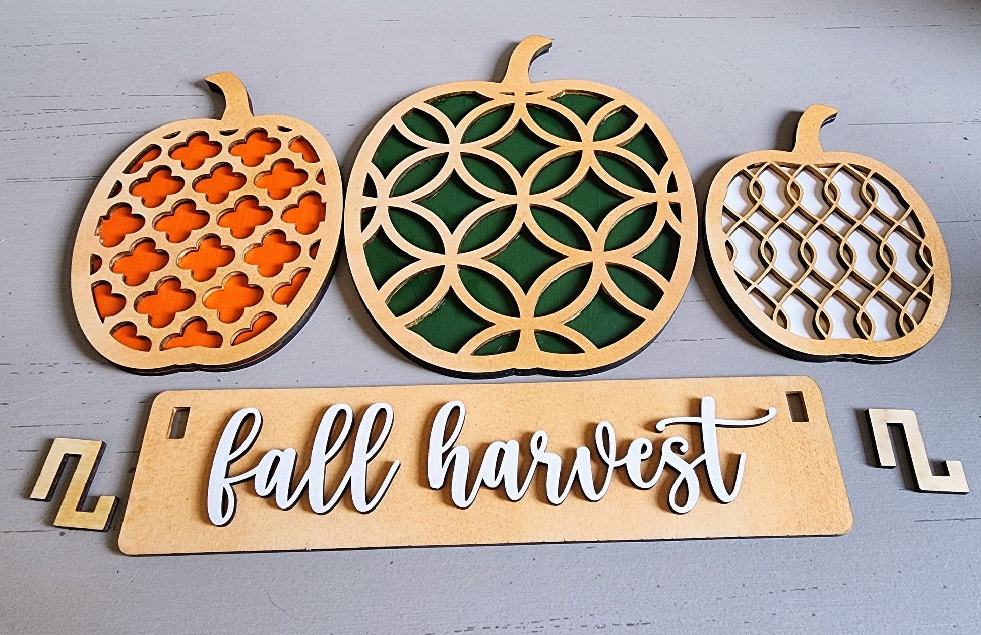 Wooden personalized fall decorations for shelves with intricate pumpkin designs and fall harvest sign