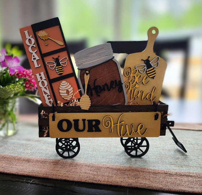 Wooden wagon insert with honey jar, bee decorations, and signs saying Local Honey and Our Hive